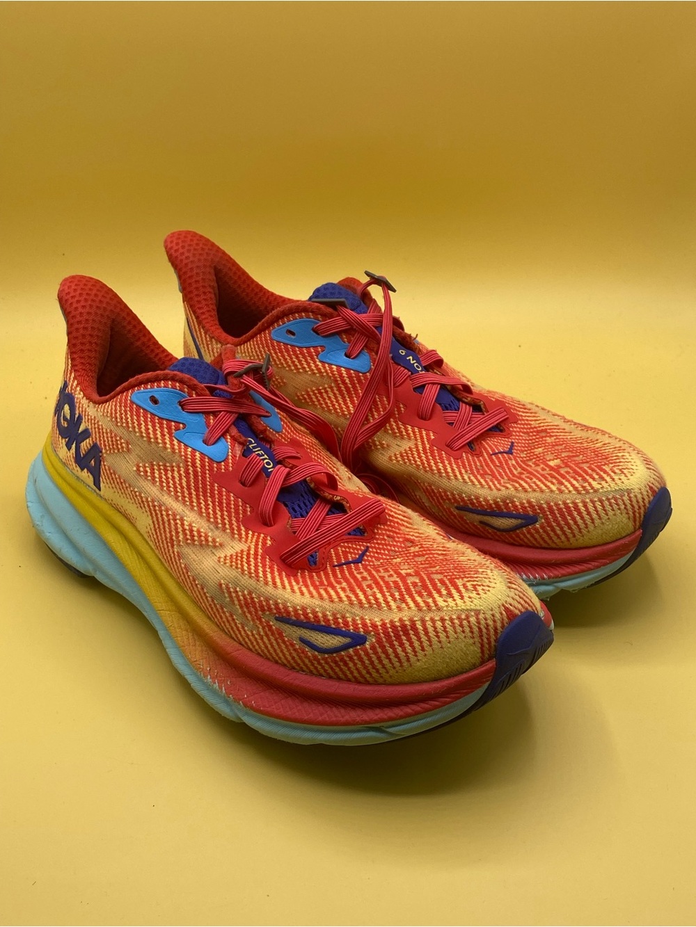 the HOKA Men's Clifton 9 Cerise/Cloudless